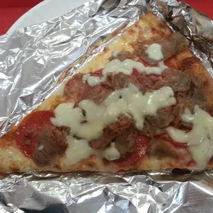 Slice with sausage and pepperoni.