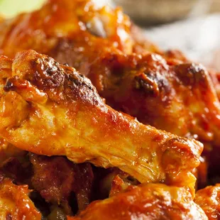 a plate of wings and sauce