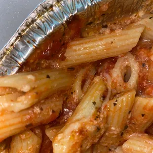 a pasta dish in a foil container