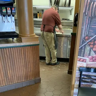 a man preparing food in a kitchen