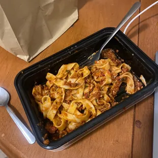 a tray of pasta and a spoon