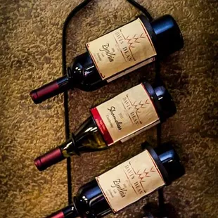 three bottles of wine in a wine rack