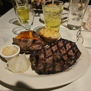 Ribeye with grilled onions and baked sweet potato