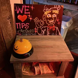 a yellow bell on a wooden shelf