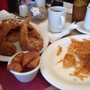 a plate of fried chicken, hash browns, and a cup of coffee