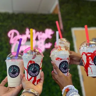 three people holding drinks