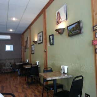 tables, chairs, and pictures on the wall