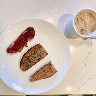 Toasted wheat bread one with jam, one with EVOO and herbs, and one plain