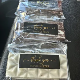 White chocolate, milk chocolate, and dark chocolate covered crispy knafeh pistachio flavor.