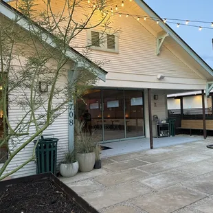 a patio with a table and chairs