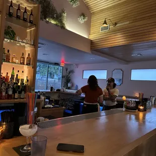 two people sitting at a bar