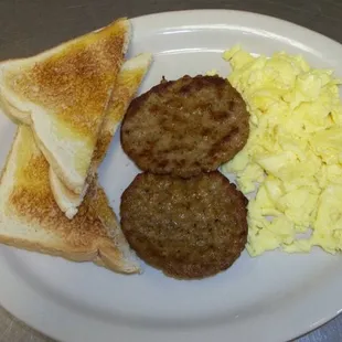 a breakfast of eggs, toast, and sausage