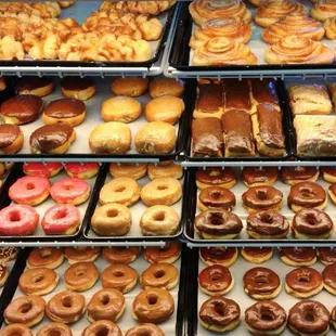 a variety of doughnuts in a display case