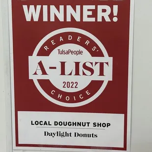 a sign for a local doughnut shop