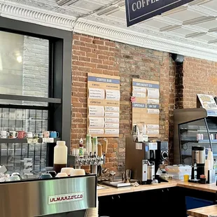 a coffee shop with a brick wall