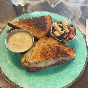 a grilled cheese sandwich with a side of macaroni and cheese