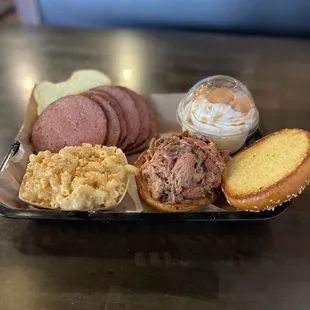 Pulled pork sandwich, brisket bologna, Mac and cheese, and bourbon banana pudding