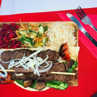 meat skewers with vegetables and rice