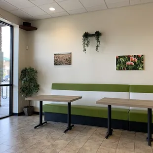 two tables and a bench in a coffee shop