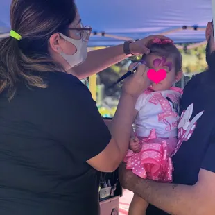 Face painter Yuri painting the birthday girl...took her time but was quick given the age of the child.