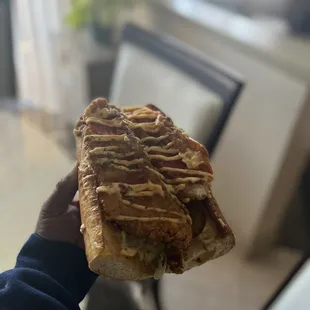  a person holding a sandwich