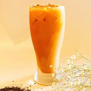 a glass of iced coffee and a flower