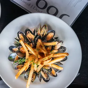 Mussels Frites - classic combination of steamed PEI mussels in a white wine, garlic and herbed butter broth accompanied by French fries