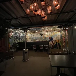 a restaurant with a mural on the wall