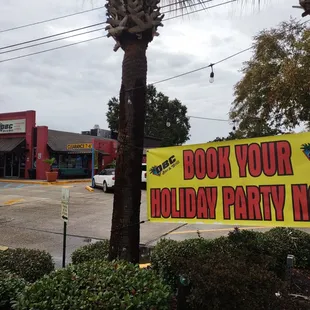 a sign for a holiday party now
