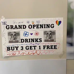 a sign that reads grand opening drinks buy 3 get 1 free