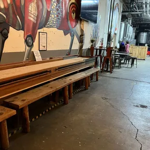 Shuffleboard and additional seating- the taco guy's counter in back.