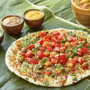 It's not-a pizza it's an uttapam-a! Made with a fermented dosa base it's fluffy on top and crispy underneath.