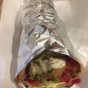 a burrito wrapped in aluminum foil