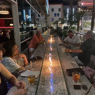 a group of people sitting at a bar