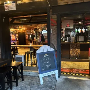 a chalkboard sign in front of a restaurant