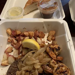 Ribeye with grilled shrimp, sautéed onions and potatoes