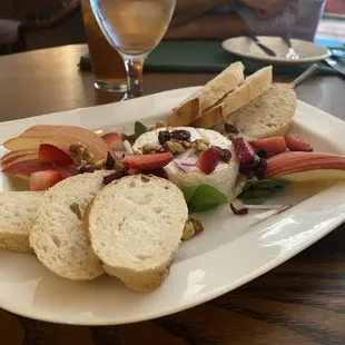 Brie Cheese.  Had apple slices, bread, strawberries, red onion, cranberries, walnuts.