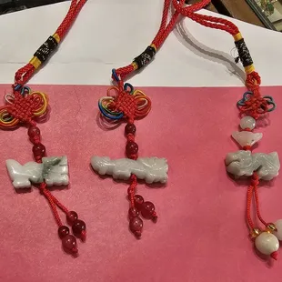 The dragon on the left has nice coloring. The middle one had good carving. The one on the right has more jade pieces...