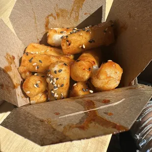 a box of donuts with sesame seeds