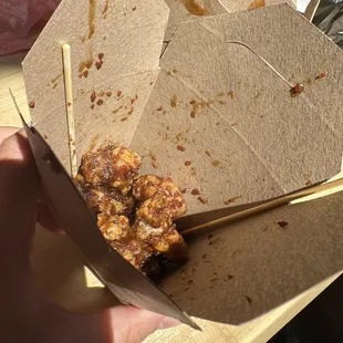 a person holding a box of food