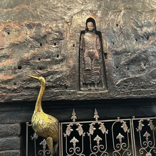 a statue of a person and a bird