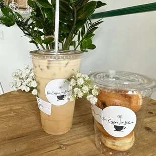 Iced oat milks latte with banana and stuffed beignets .