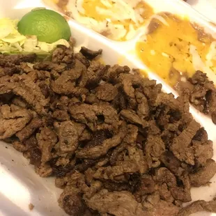 Carne asada plate- carne asada, beans, rice, guacamole, lettuce,&amp; tortillas. The portions are large. The meat was tender &amp; had good flavor.