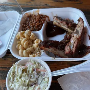 One meat plate with ribs, Mac and cheese, cowboy beans, and a side of coleslaw