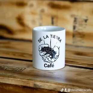 a white coffee mug with a black cat on it