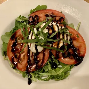 sliced tomatoes with arugula and burrata