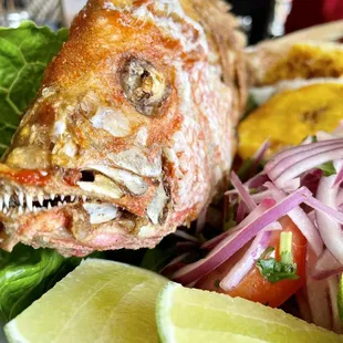 a whole fish on a bed of lettuce