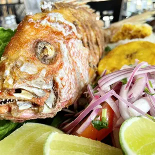 a whole fish on a bed of lettuce