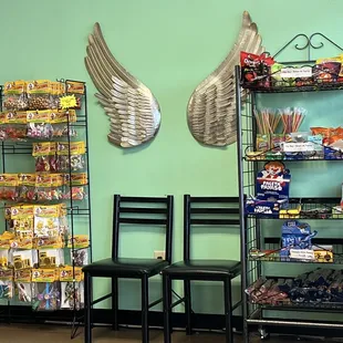 two chairs in front of a shelf of snacks