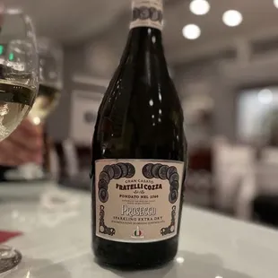 a bottle of wine and a glass of wine